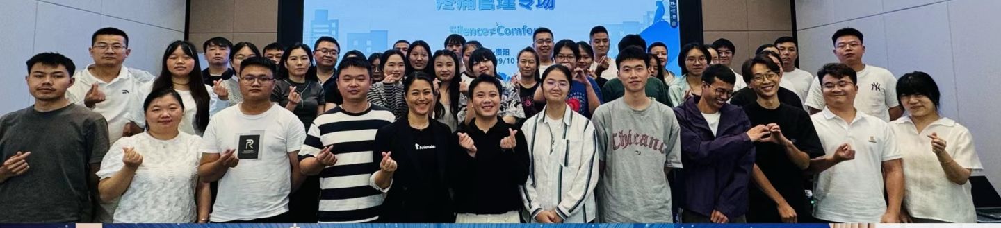 Group of people posing together in front of large projector screen