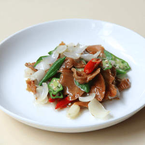Colourful vegan food presented on white round plate