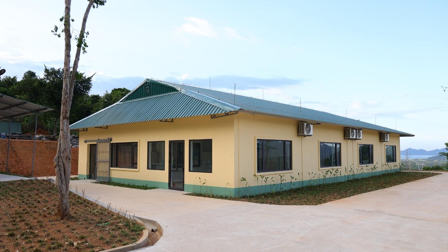 One level building on a path with mountains in background