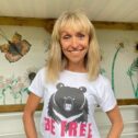 Woman facing camera and smiling wearing a Be Free tshirt