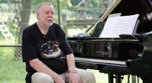 Rick Wakeman sits at his piano during a recital for rescued moon bears